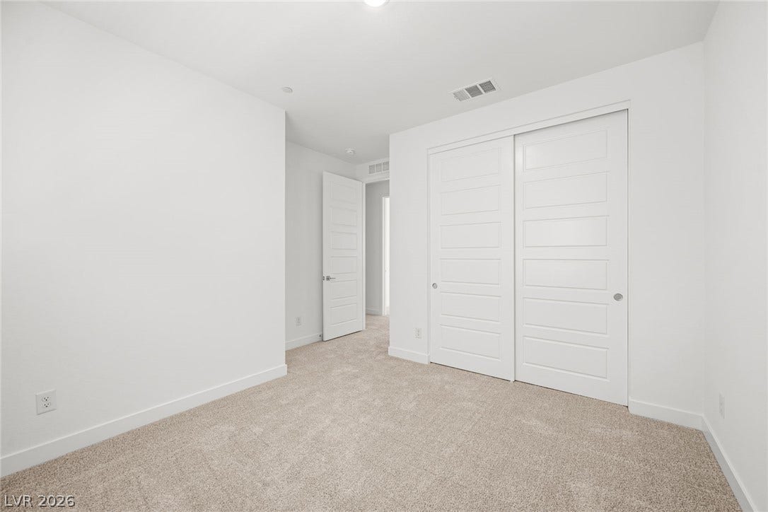 11823 Mimicking Song Lane, Las Vegas, NV 89138 Plush carpeting and sliding closet doors define this serene, minimalist bedroom space.