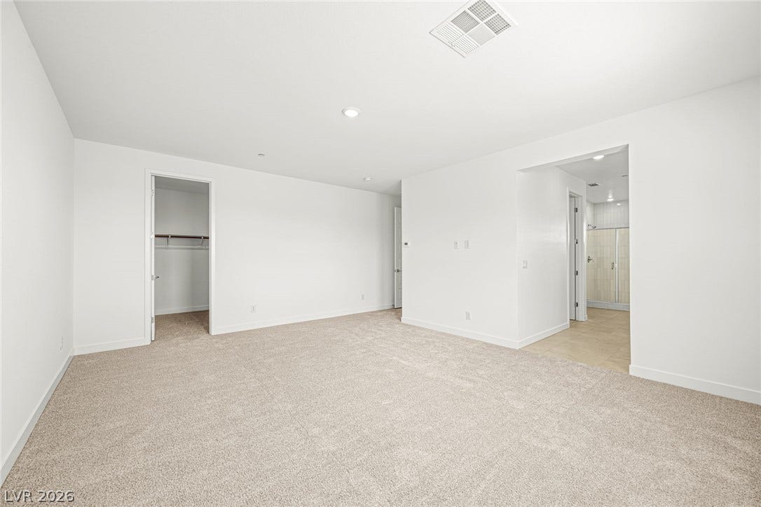 11823 Mimicking Song Lane, Las Vegas, NV 89138 Soft carpeting underfoot defines this airy bedroom featuring a closet and an attached bathroom.