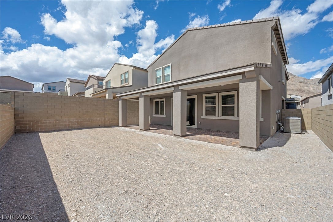 11823 Mimicking Song Lane, Las Vegas, NV 89138 A spacious backyard area features a covered patio and a clean gravel yard.