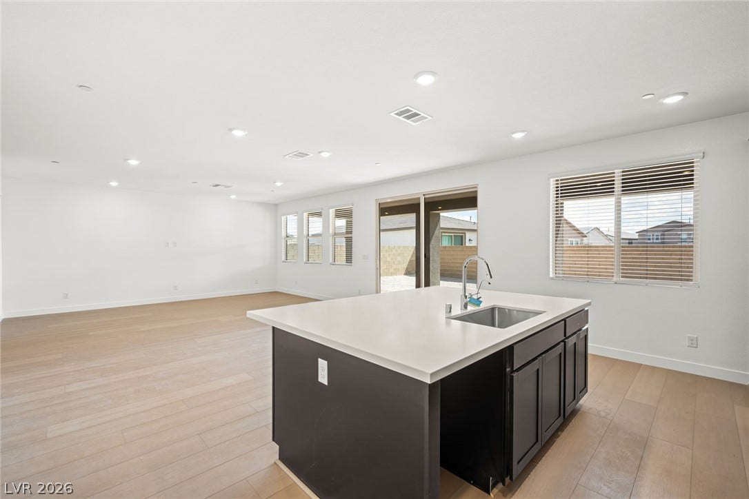 11823 Mimicking Song Lane, Las Vegas, NV 89138 Gleaming hardwood floors and a spacious island anchor this expansive, open-concept living space.