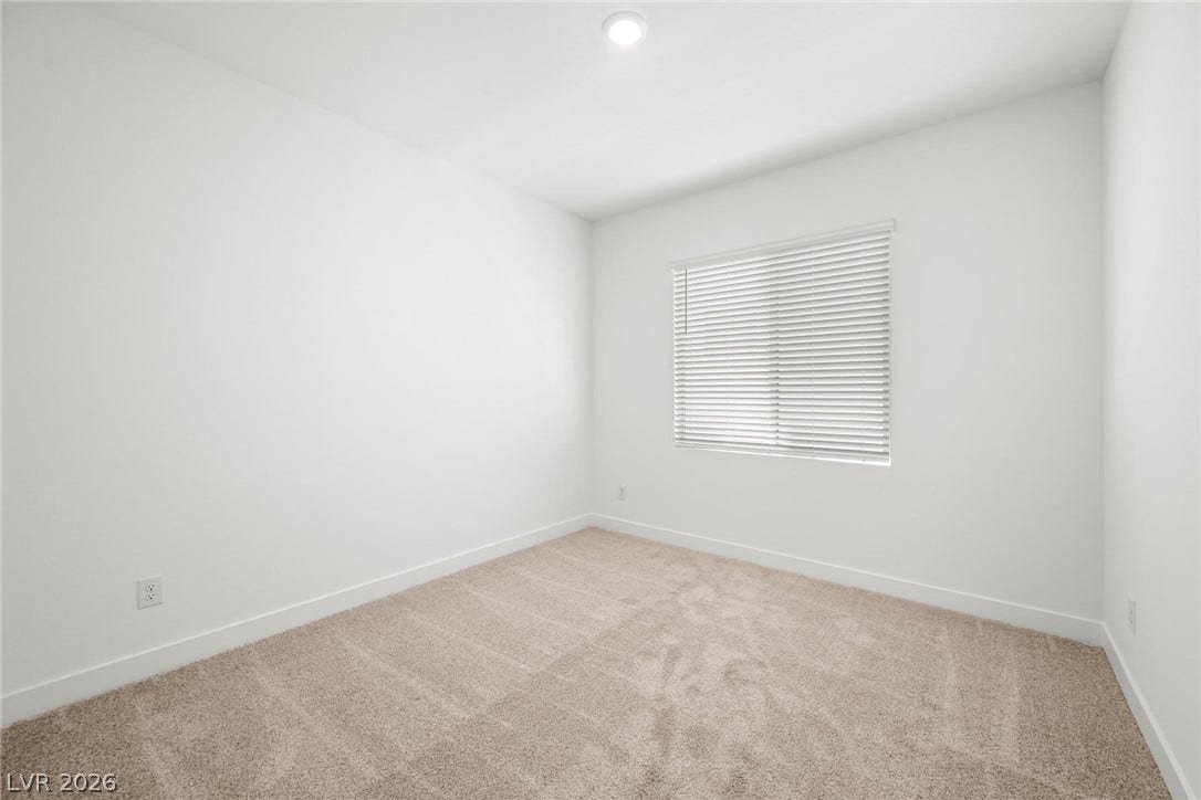 11823 Mimicking Song Lane, Las Vegas, NV 89138 Plush carpeting and a large window define this versatile secondary bedroom space.