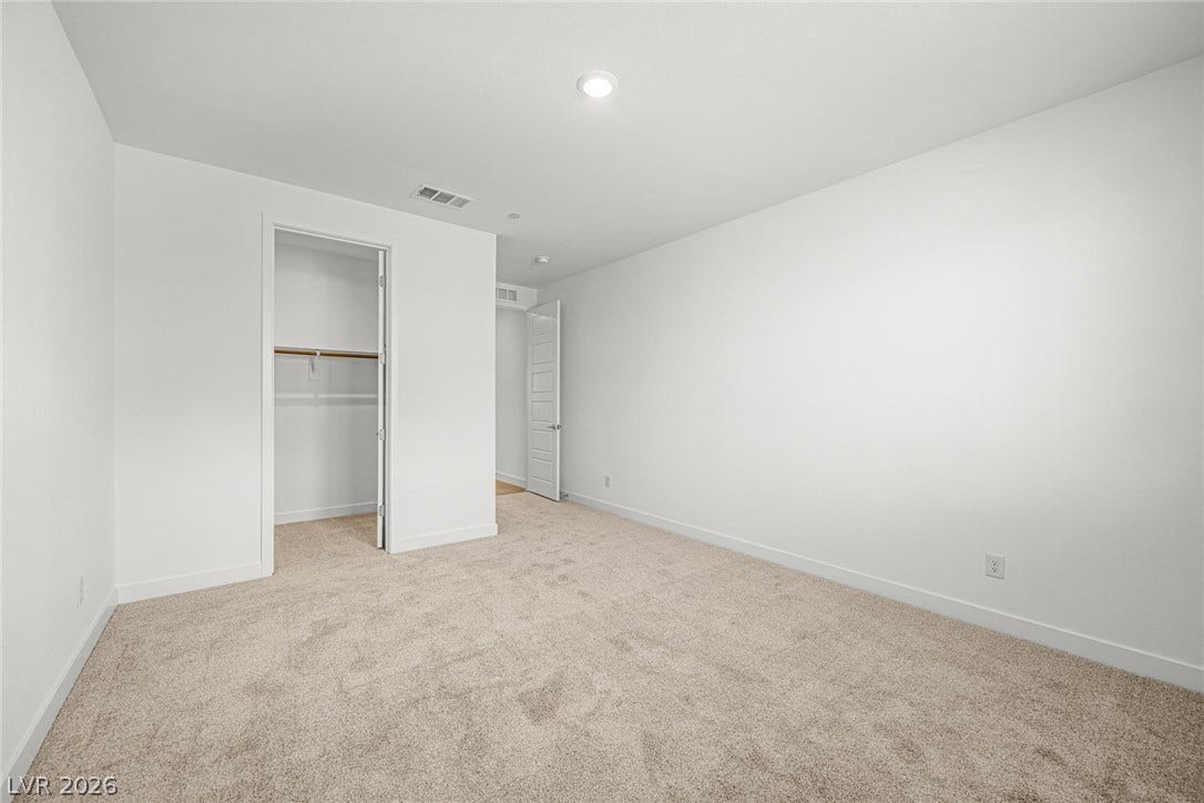 11823 Mimicking Song Lane, Las Vegas, NV 89138 Plush carpeting and crisp white walls define this clean, versatile bedroom space.