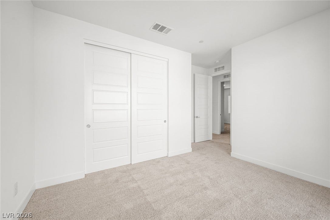 11823 Mimicking Song Lane, Las Vegas, NV 89138 Soft carpeting pairs with clean lines and integrated closets in this quiet bedroom.