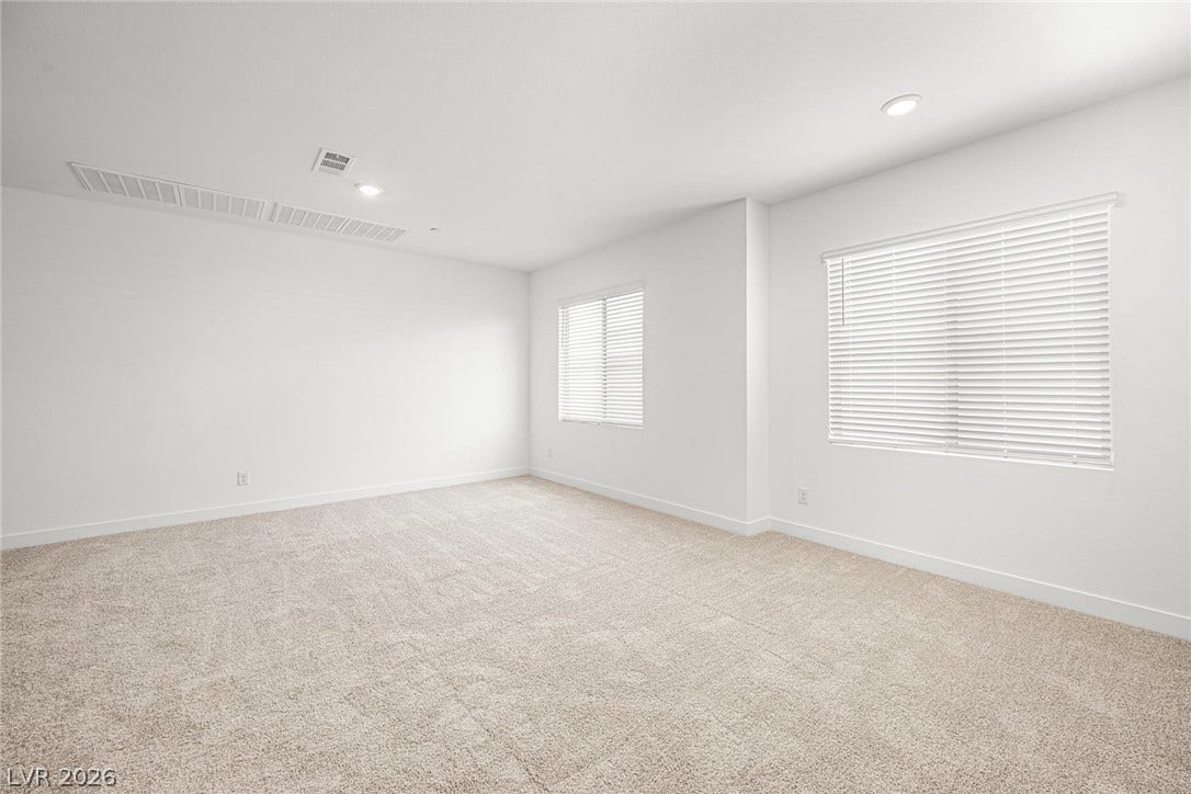 11823 Mimicking Song Lane, Las Vegas, NV 89138 Soft carpeting pairs with recessed lighting and dual windows to create a comfortable, minimalist retreat.