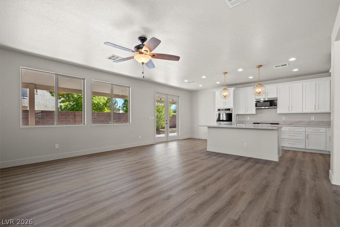 1874 Nature Park Drive, North Las Vegas, NV 89084 Clean lines and wood-look flooring anchor this airy open-concept living space and kitchen.