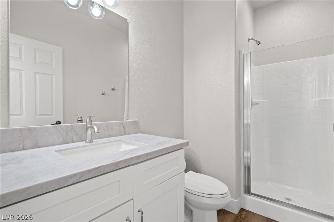 1874 Nature Park Drive, North Las Vegas, NV 89084 2nd dairy suite bathroom with Clean lines and a walk-in shower define this modern bathroom with a stone-counter vanity.
