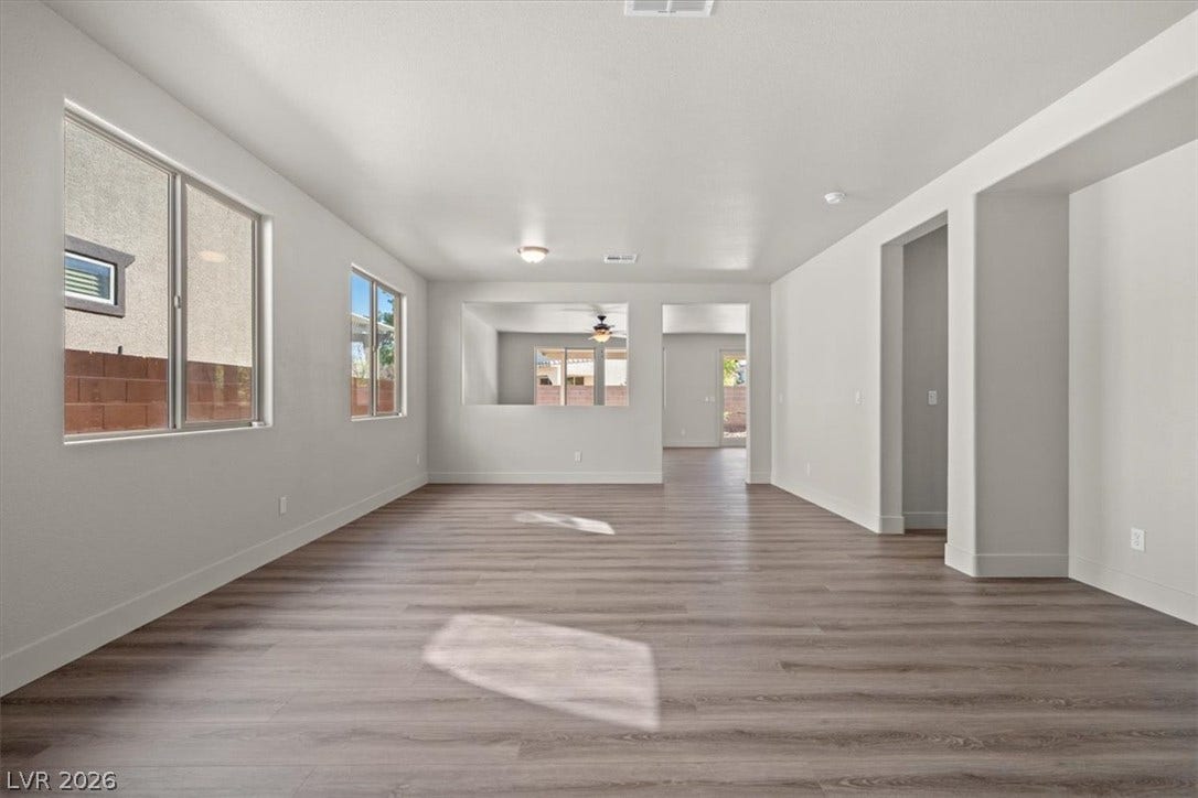 1874 Nature Park Drive, North Las Vegas, NV 89084 Smooth wood-look flooring and crisp neutral walls define this versatile open living space.