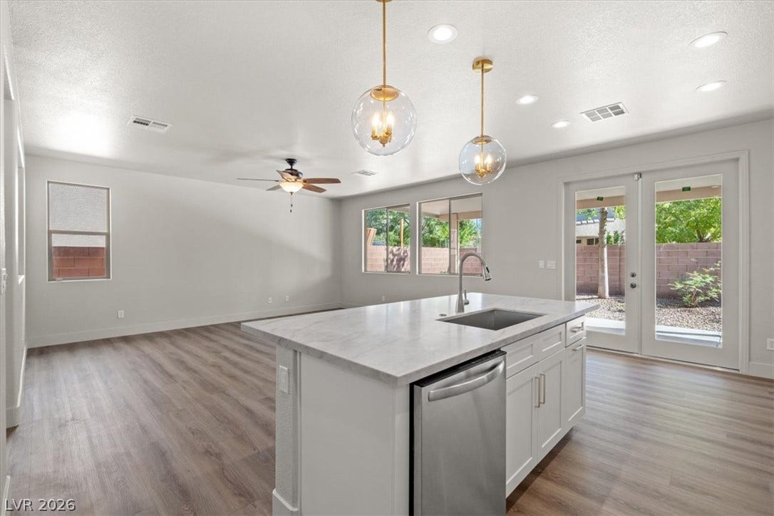 1874 Nature Park Drive, North Las Vegas, NV 89084 Gleaming wood-look floors unite this airy open layout with the clean-lined island kitchen.