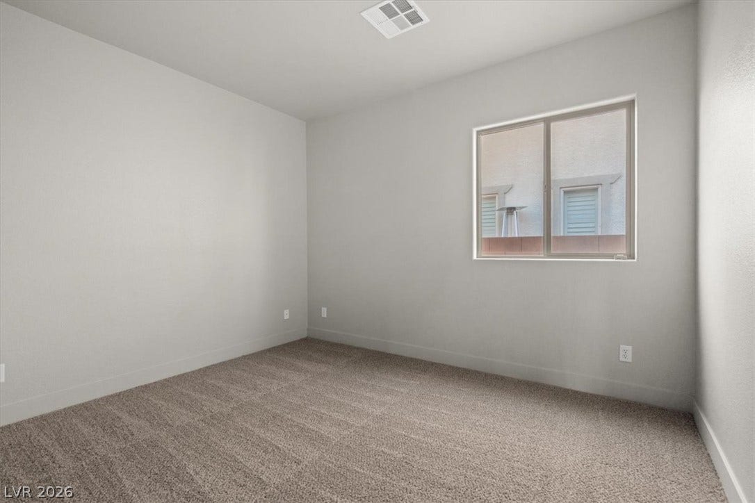 1874 Nature Park Drive, North Las Vegas, NV 89084 Plush carpeting and a classic window frame this versatile secondary bedroom space.