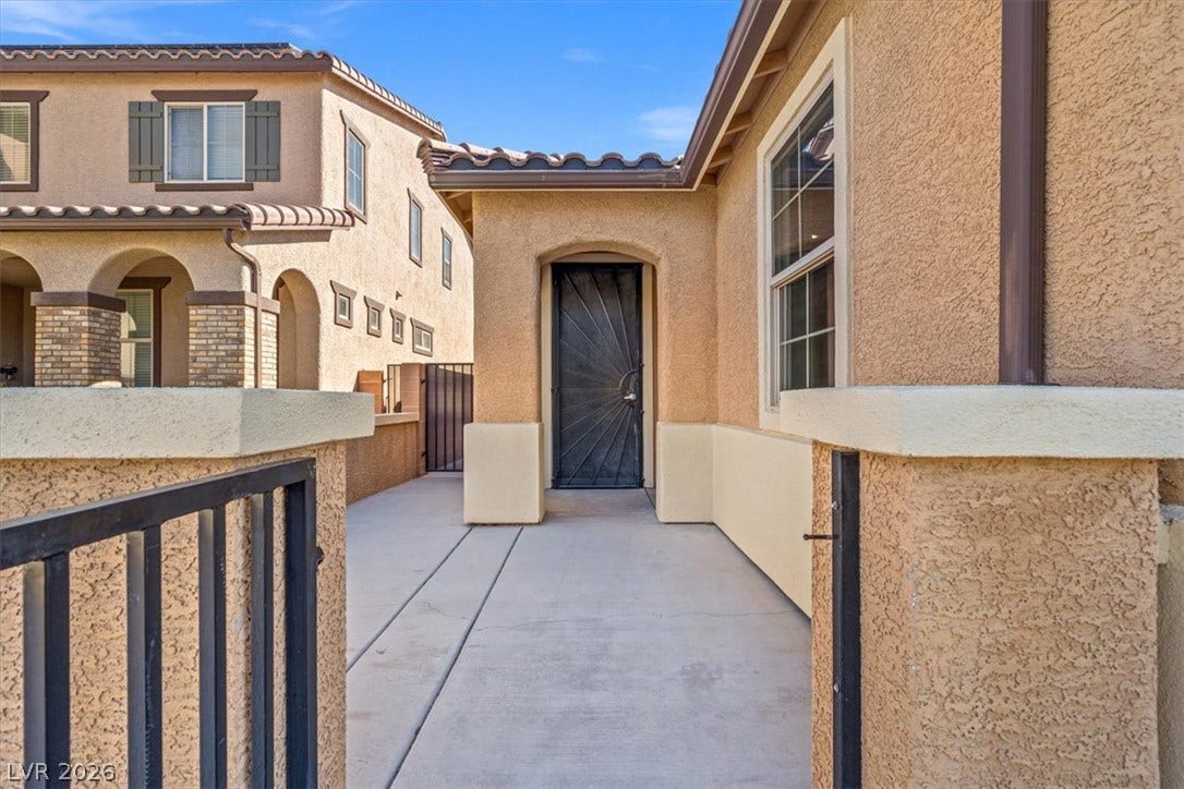 1874 Nature Park Drive, North Las Vegas, NV 89084 A secure gated courtyard entry welcomes visitors to this elegant stucco home.