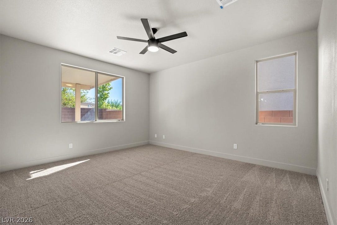 1874 Nature Park Drive, North Las Vegas, NV 89084 Plush carpeting and natural light define this versatile, clean-lined bedroom space.