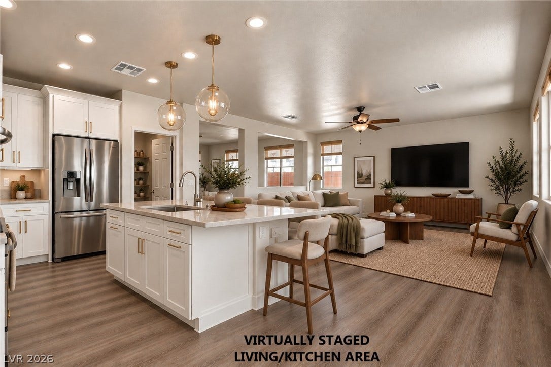 1874 Nature Park Drive, North Las Vegas, NV 89084 Recessed lighting and warm wood-look flooring enhance this open-concept main living and culinary space.