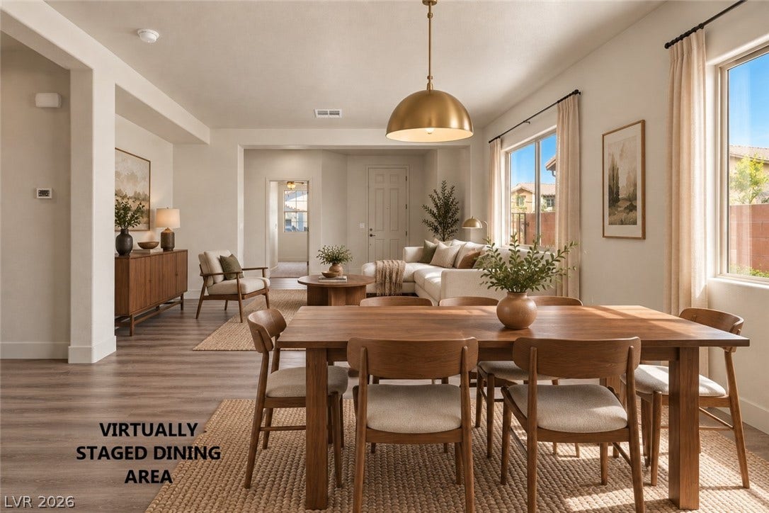 1874 Nature Park Drive, North Las Vegas, NV 89084 Warm wood-look flooring pairs with classic arched entries in an airy open-concept layout.