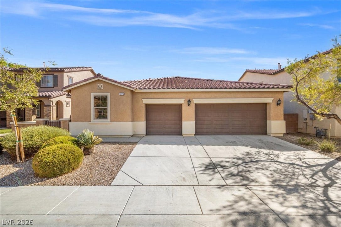 1874 Nature Park Drive, North Las Vegas, NV 89084 A spacious driveway leads directly to the multi-car garage of this single-level home.