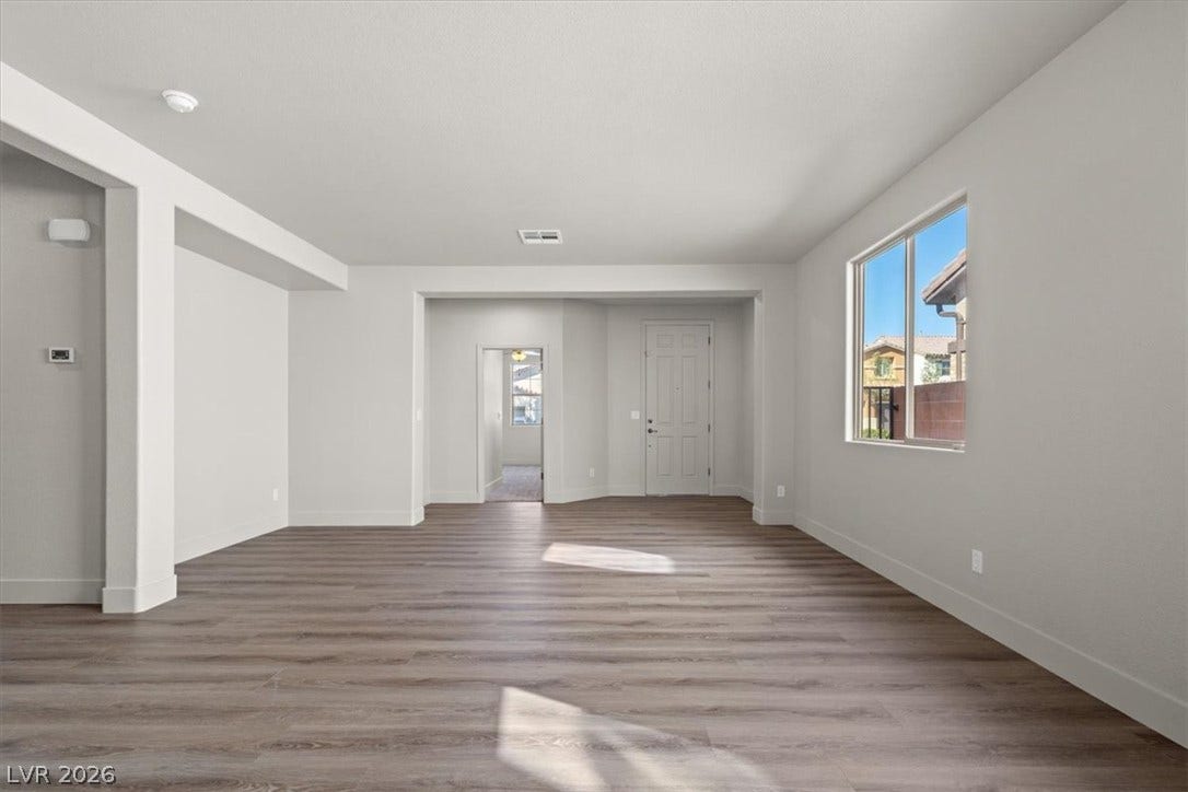 1874 Nature Park Drive, North Las Vegas, NV 89084 Clean lines and durable plank flooring define this versatile, open living area.
