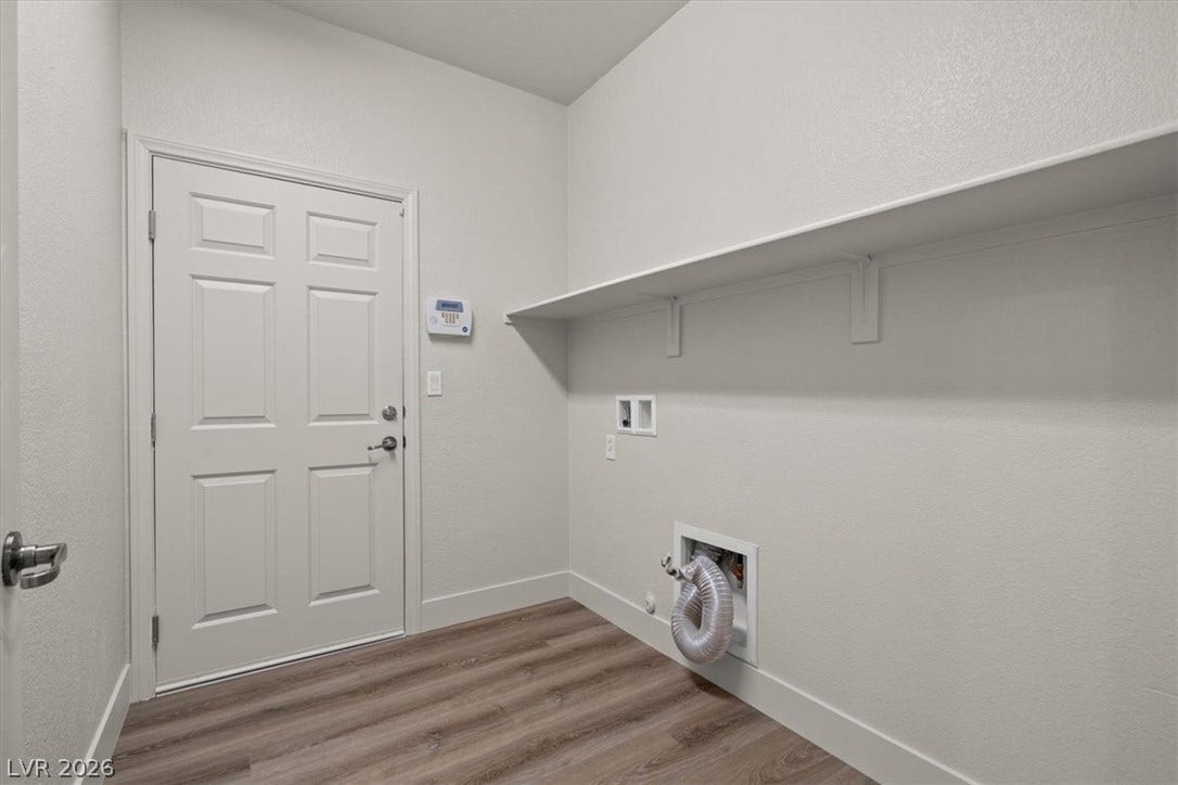 1874 Nature Park Drive, North Las Vegas, NV 89084 Functional laundry room area features vinyl plank flooring and built-in shelving.
