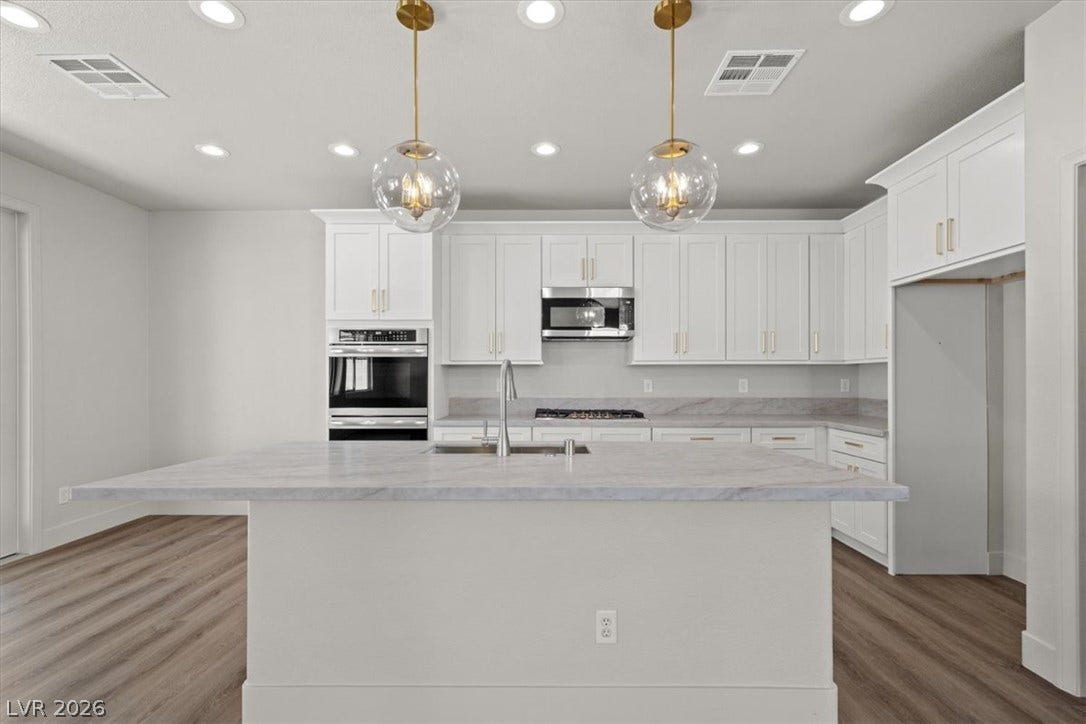 1874 Nature Park Drive, North Las Vegas, NV 89084 Polished stone countertops and seamless cabinetry define this contemporary culinary workspace.