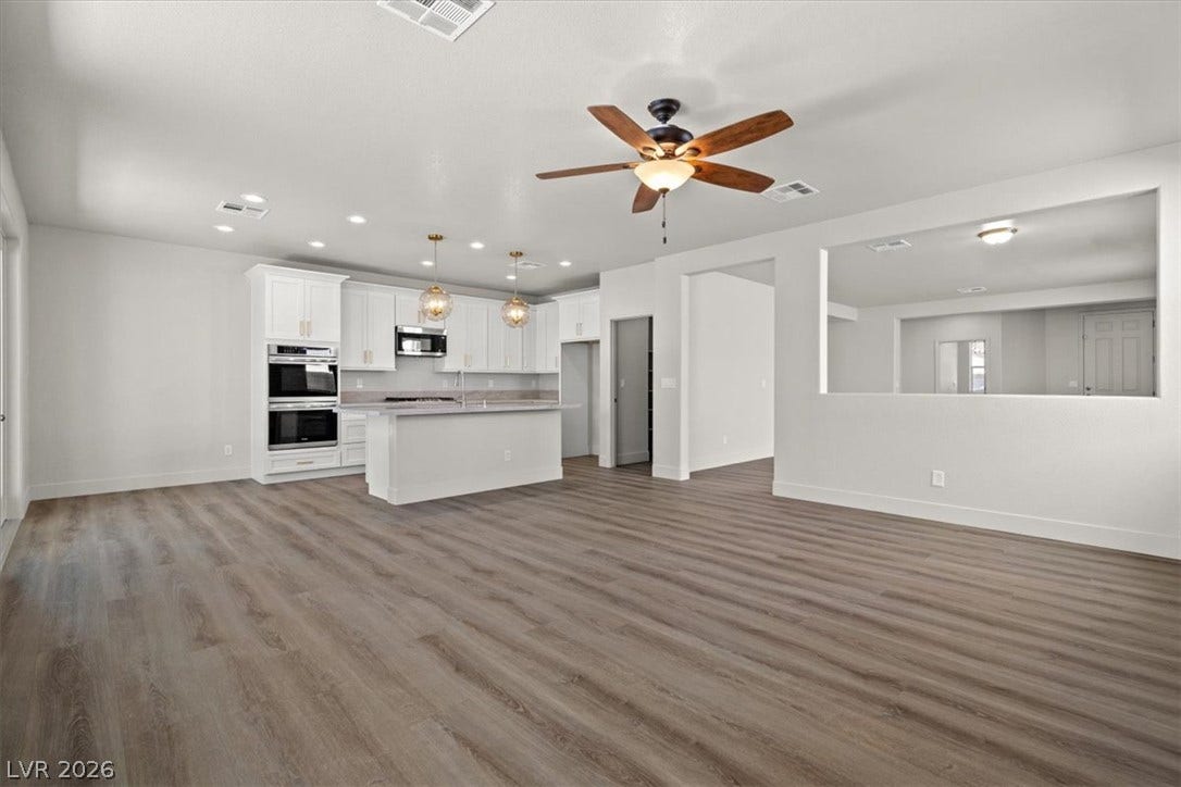 1874 Nature Park Drive, North Las Vegas, NV 89084 An open floorplan seamlessly connects the airy living area to a modern kitchen.