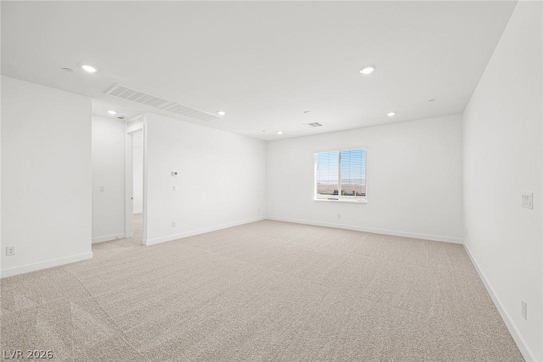 A spacious, naturally illuminated room presents endless possibilities for customization and comfort.