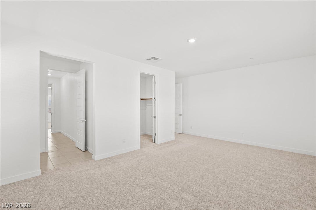 A spacious room offers comfortable carpeting and convenient closet space, ready for personalization.