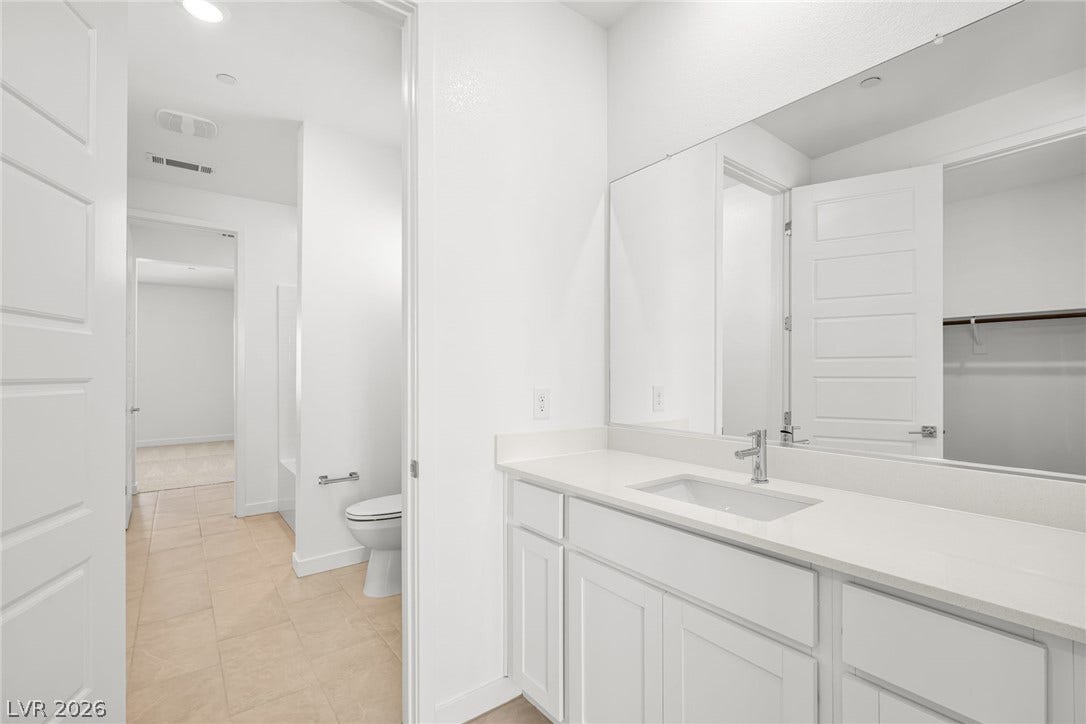 A pristine bathroom vanity with a spacious counter reflects bright, clean lines and modern design.