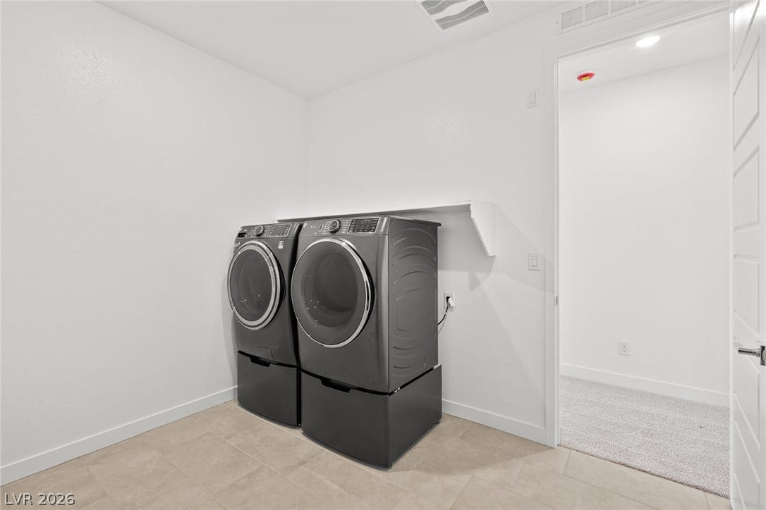 A well-appointed laundry area offers convenient, modern washer and dryer units for effortless home management.