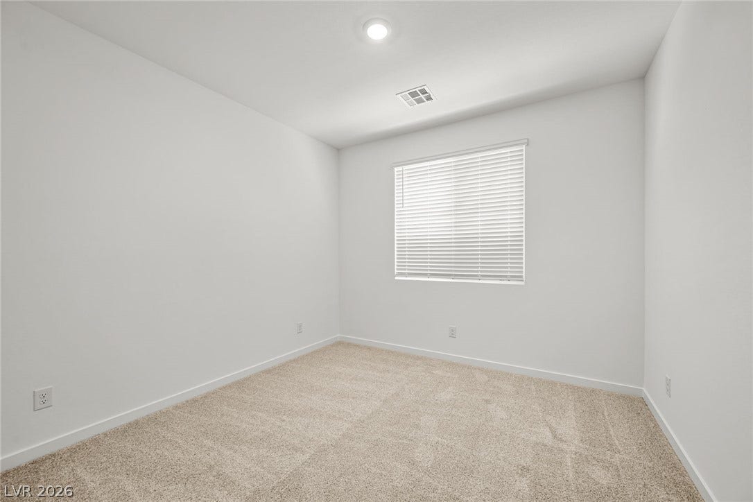1663 Capri Falls Court, Henderson, NV 89011 Plush carpeting and a large window create a serene atmosphere in this versatile bedroom.