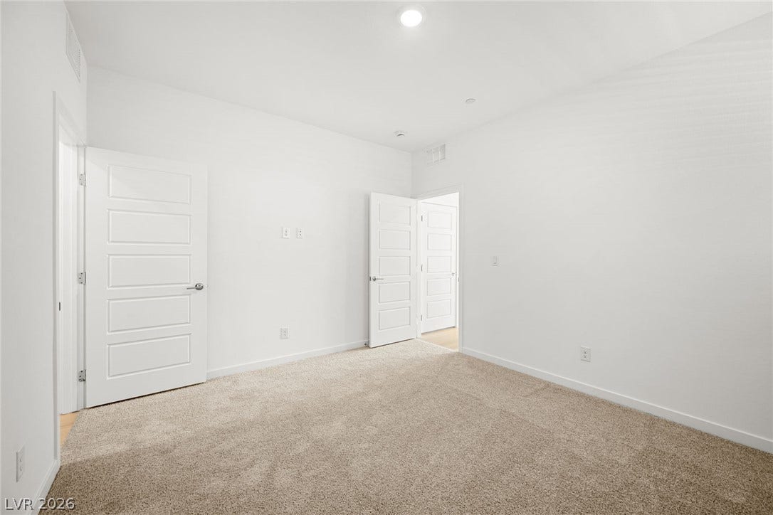 1663 Capri Falls Court, Henderson, NV 89011 Plush carpeting and recessed lighting create a comfortable atmosphere in this versatile bedroom space.