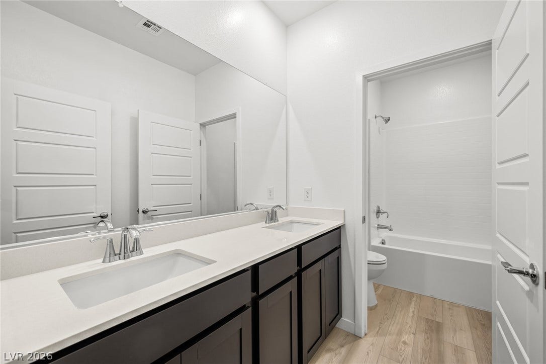 1663 Capri Falls Court, Henderson, NV 89011 Clean lines and a spacious dual vanity highlight this contemporary full bathroom.