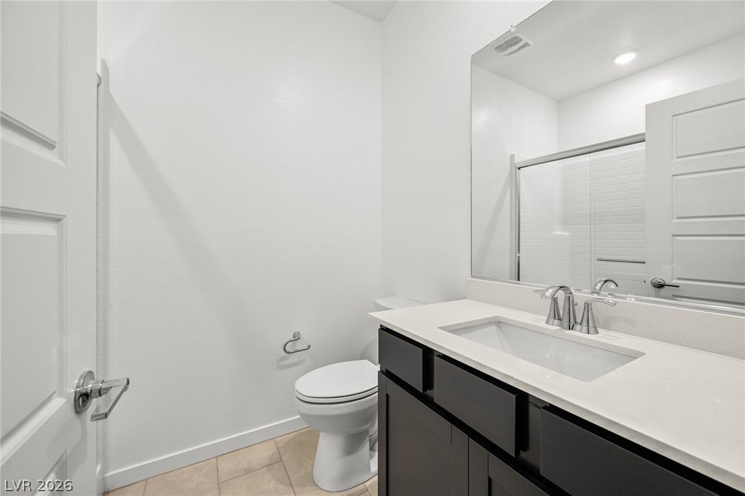 1663 Capri Falls Court, Henderson, NV 89011 Clean lines and stone counters highlight this modern bathroom space.