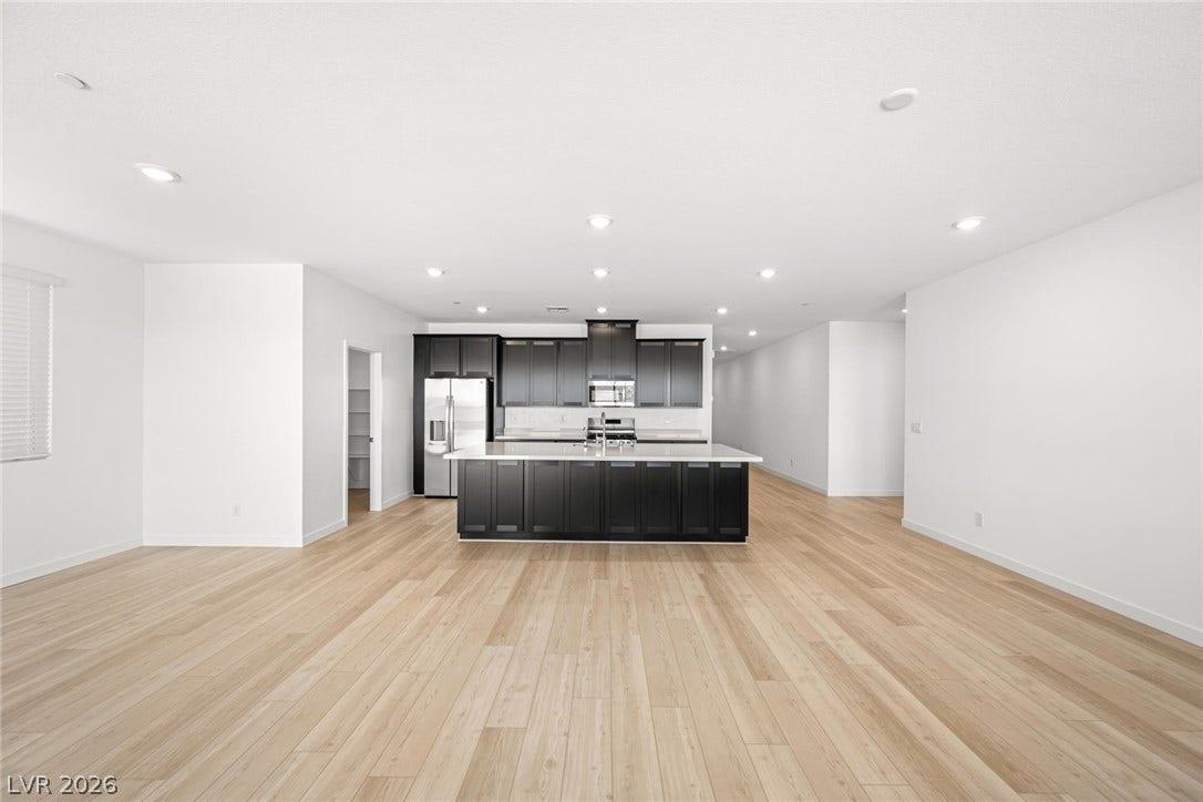 1663 Capri Falls Court, Henderson, NV 89011 Clean lines and warm wood floors define this expansive open-concept living and dining area.