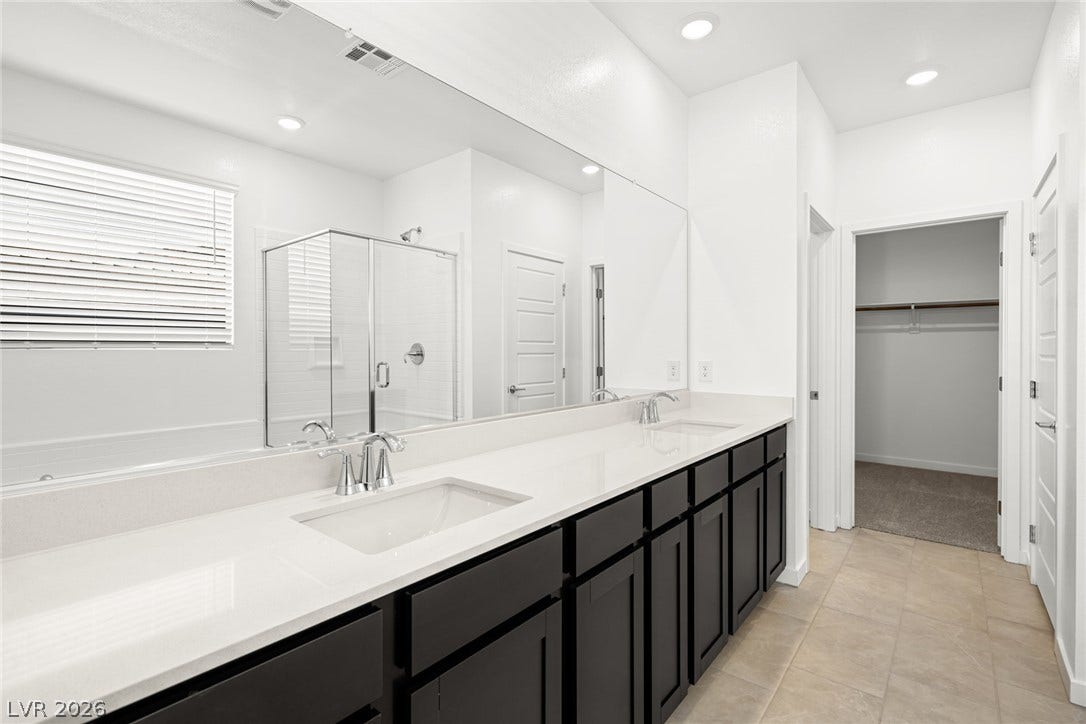 1663 Capri Falls Court, Henderson, NV 89011 Clean lines and a spacious double vanity define this modern primary bathroom suite.