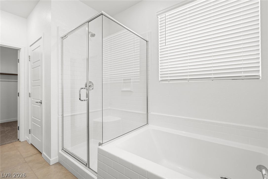 1663 Capri Falls Court, Henderson, NV 89011 Tiled surrounds and glass enclosures define the soaking tub and walk-in shower.