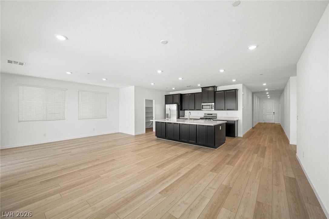 1663 Capri Falls Court, Henderson, NV 89011 An open concept design seamlessly connects the spacious living area to the modern kitchen.
