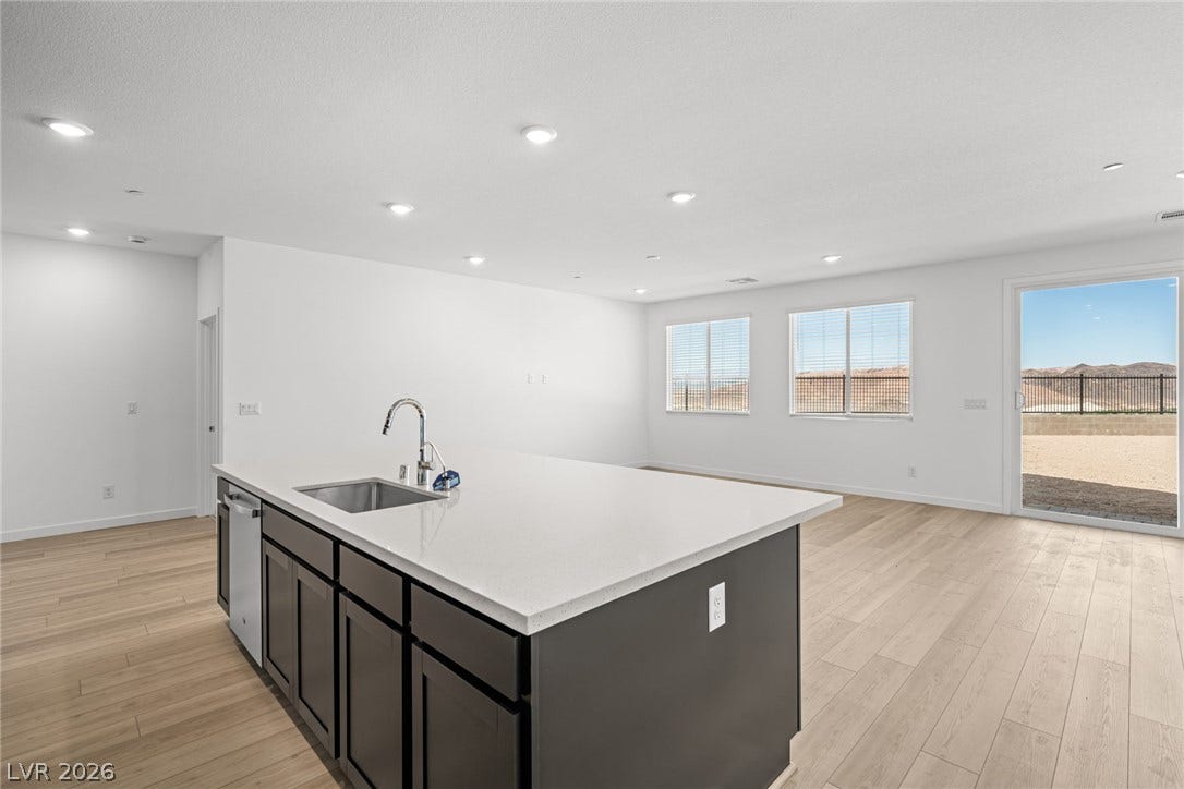 1663 Capri Falls Court, Henderson, NV 89011 An open floorplan seamlessly connects the central kitchen island to the main living areas.