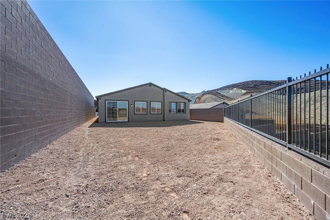 1663 Capri Falls Court, Henderson, NV 89011 An enclosed backyard space features high block walls and distant desert mountain views.