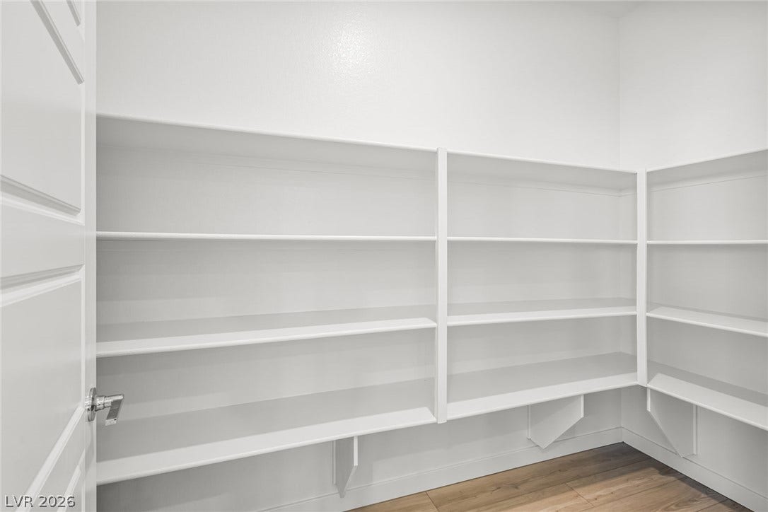 1663 Capri Falls Court, Henderson, NV 89011 Ample built-in shelving and rich wood flooring maximize organization in this storage space.