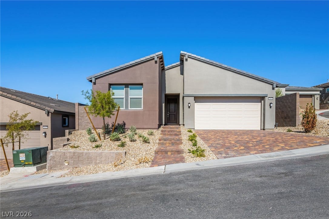 1663 Capri Falls Court, Henderson, NV 89011 Clean architectural lines define this modern single-story residence with desert landscaping.