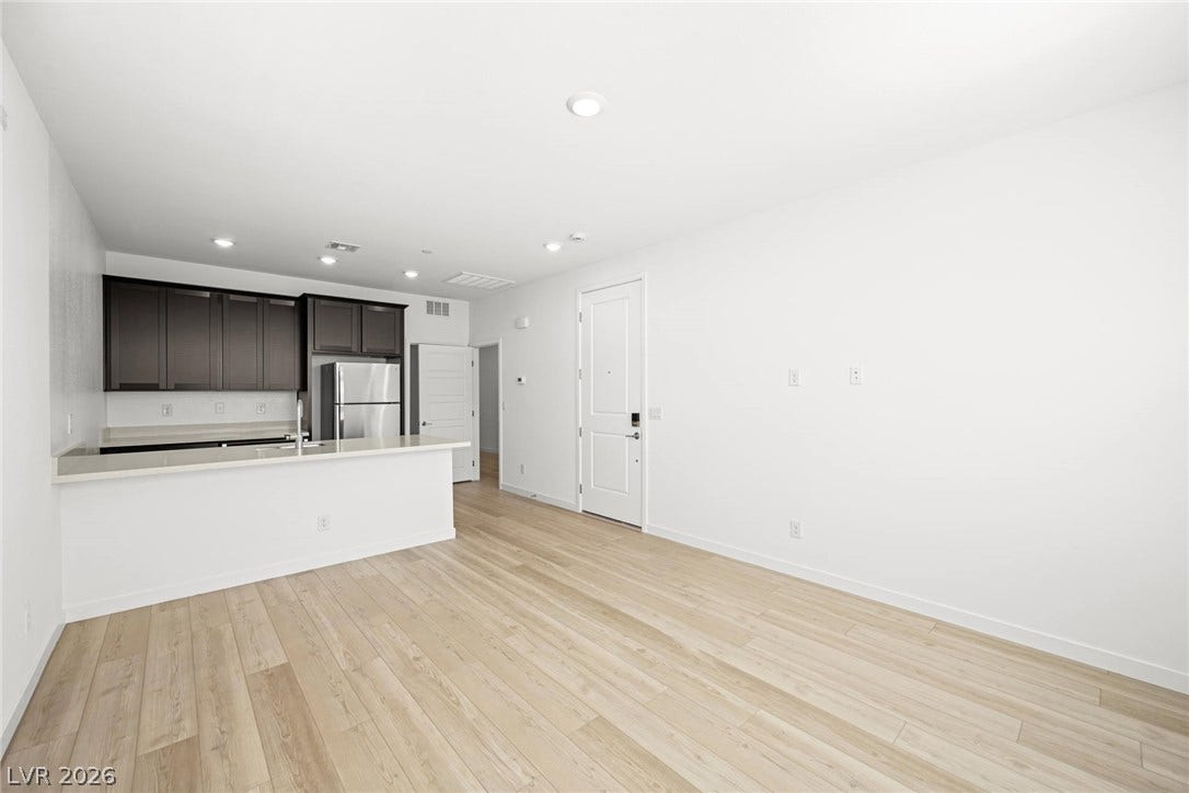 1663 Capri Falls Court, Henderson, NV 89011 Smooth wood floors flow seamlessly through this open-concept living area and adjacent kitchen.