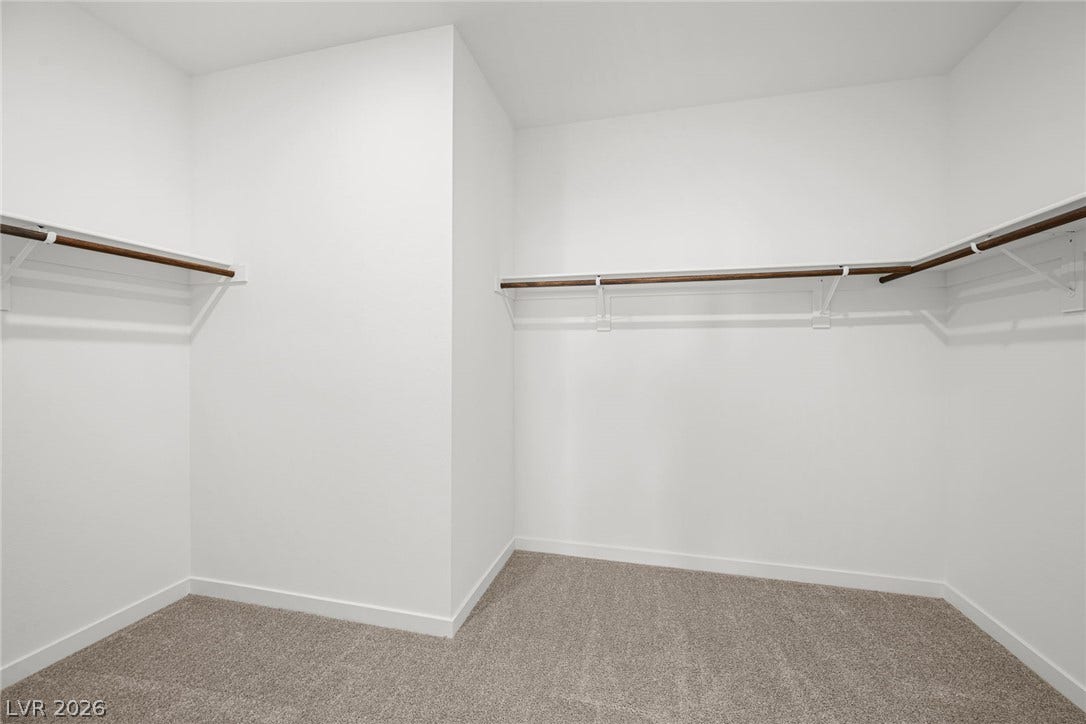 1663 Capri Falls Court, Henderson, NV 89011 A spacious walk-in closet includes built-in hanging rods, overhead shelving, and comfortable carpeting.