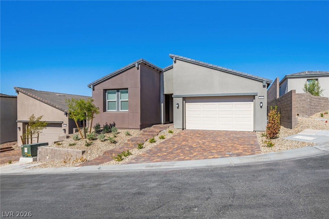 1663 Capri Falls Court, Henderson, NV 89011 Clean architectural lines and a paver driveway define this modern single-story desert home.