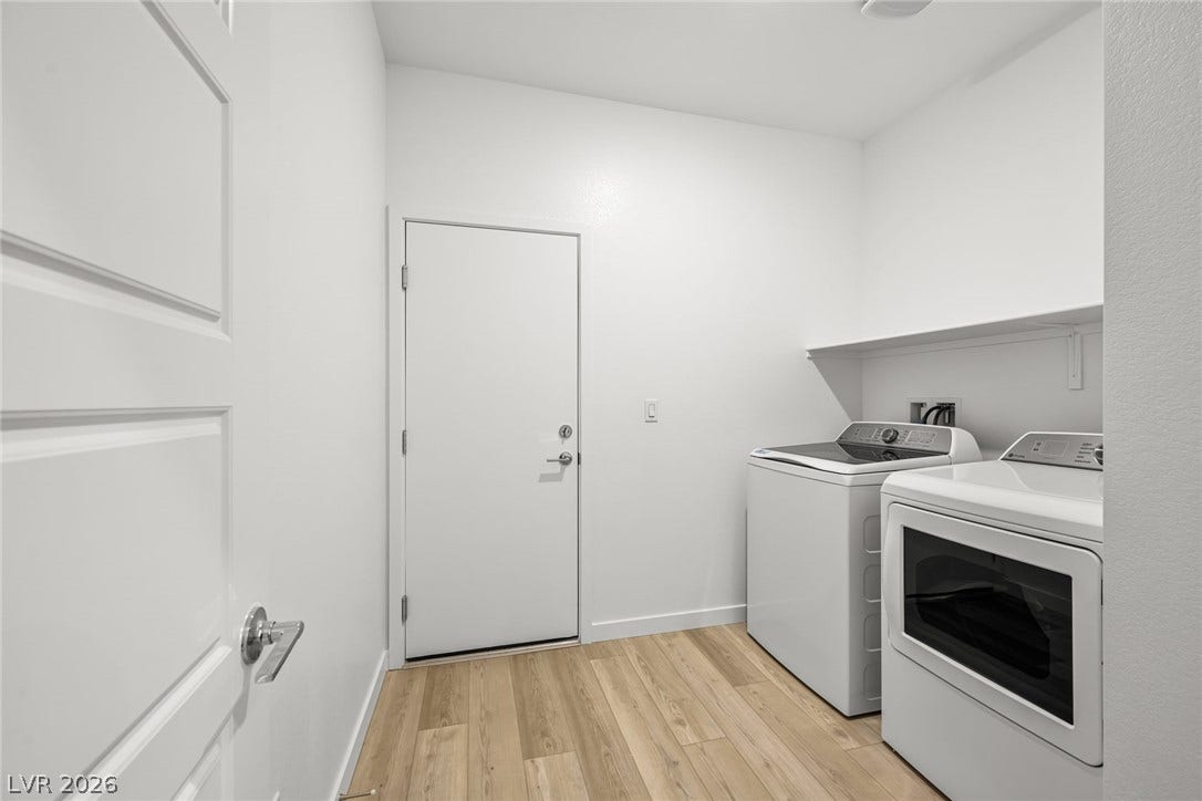 1663 Capri Falls Court, Henderson, NV 89011 Smooth wood-look flooring and built-in shelving define this functional laundry utility area.
