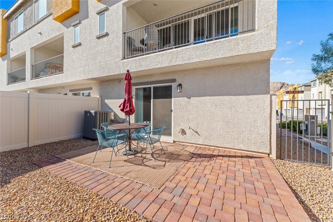 10059 Dazzling Sunrays Avenue, Las Vegas, NV 89129 An inviting paved patio area extends directly from the lower level sliding glass doors.