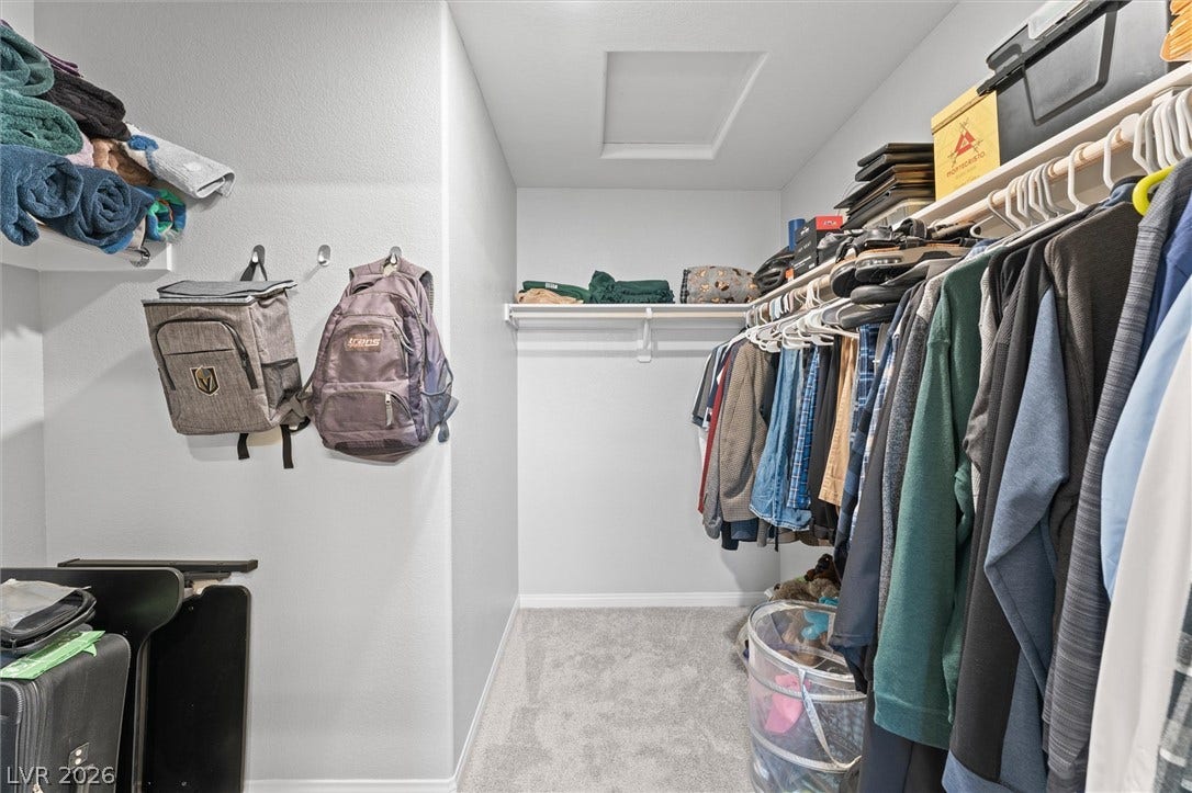 10059 Dazzling Sunrays Avenue, Las Vegas, NV 89129 A spacious walk-in closet includes wall-to-wall carpeting and built-in shelving.