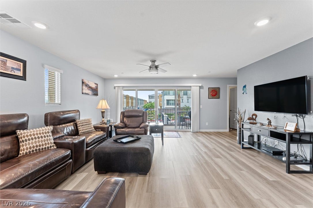 10059 Dazzling Sunrays Avenue, Las Vegas, NV 89129 An open living space highlights clean lines, durable wood-look flooring, and recessed lighting.