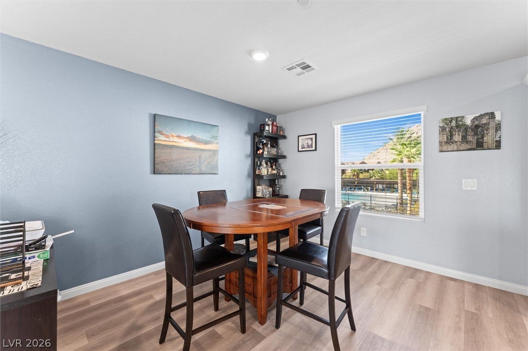 10059 Dazzling Sunrays Avenue, Las Vegas, NV 89129 Warm wood flooring and an abundance of natural light define this versatile dining space.
