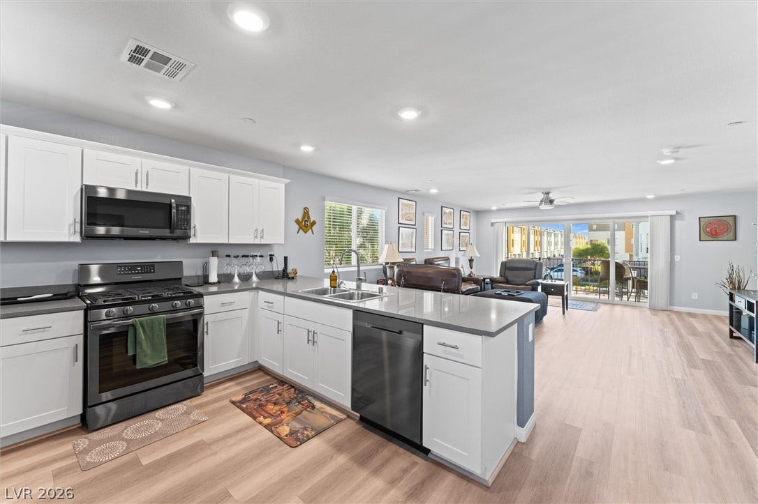 10059 Dazzling Sunrays Avenue, Las Vegas, NV 89129 An open floorplan seamlessly connects the modern kitchen and airy living space.