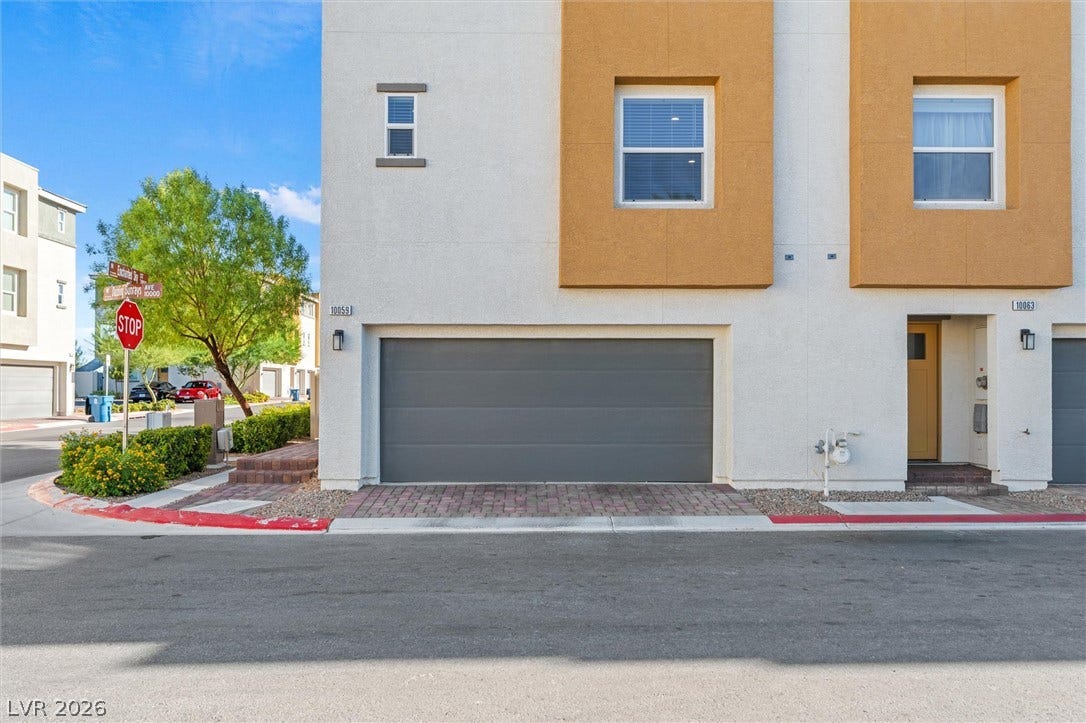 10059 Dazzling Sunrays Avenue, Las Vegas, NV 89129 A modern multi-level exterior highlights geometric stucco details and a spacious integrated garage.