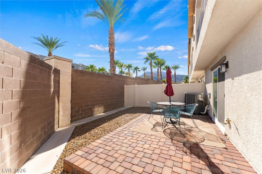 10059 Dazzling Sunrays Avenue, Las Vegas, NV 89129 A private paved courtyard provides a serene outdoor space framed by towering palm trees.