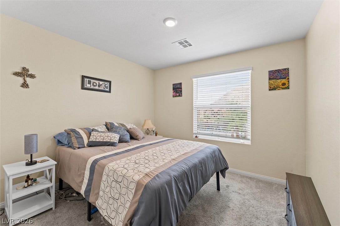 10059 Dazzling Sunrays Avenue, Las Vegas, NV 89129 Plush carpeting and a wide window create a comfortable, inviting atmosphere.